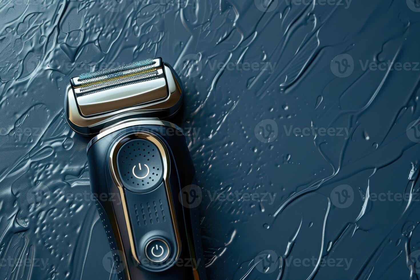 Electric razor resting on a wet, textured surface with a dark background photo