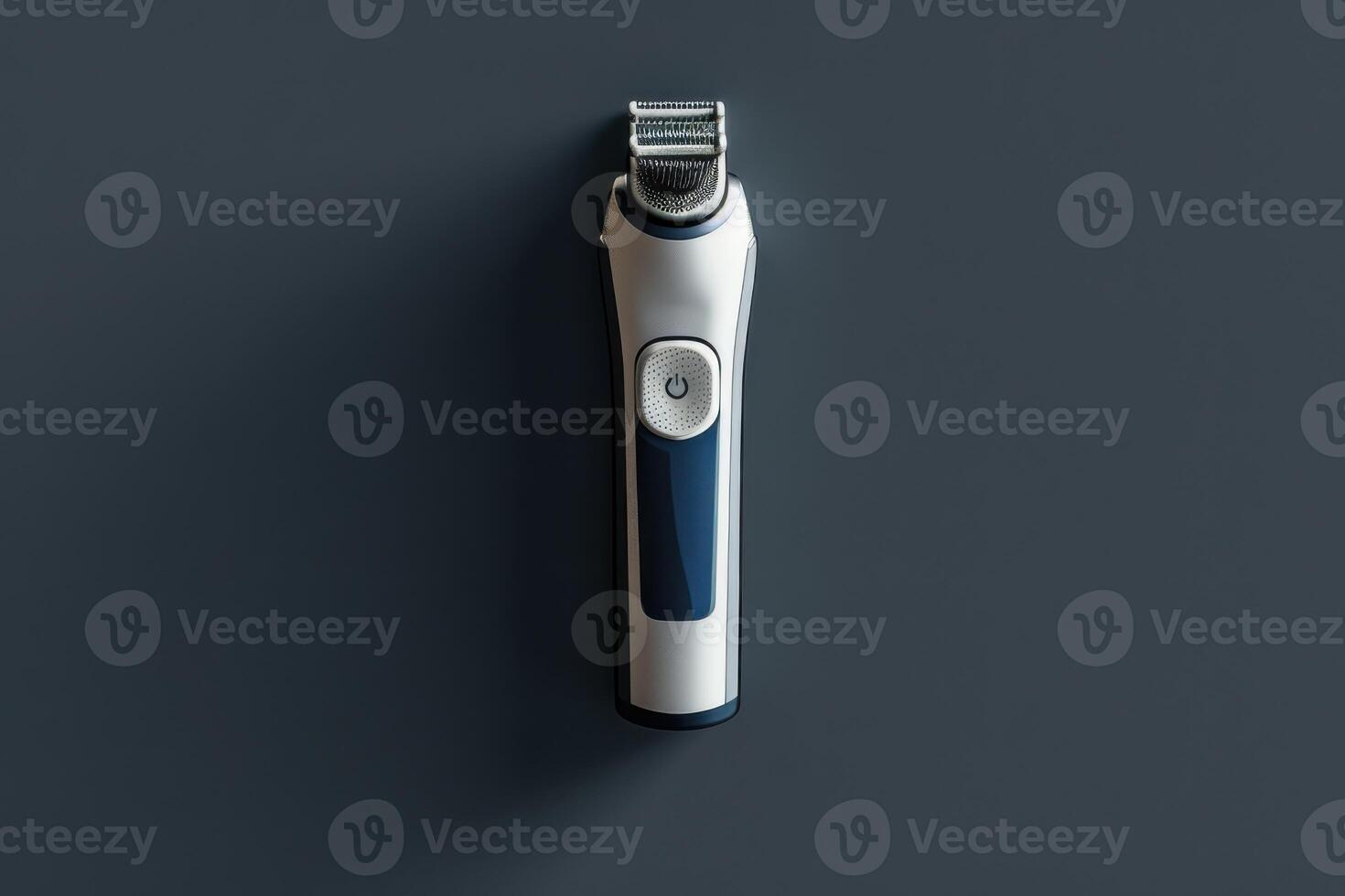 Modern hair clippers on a dark surface with a sleek design and simple button photo