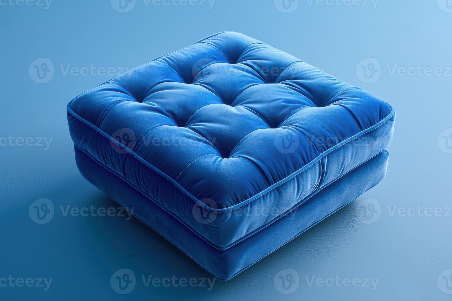 Soft blue upholstered cushion on a smooth blue background photo