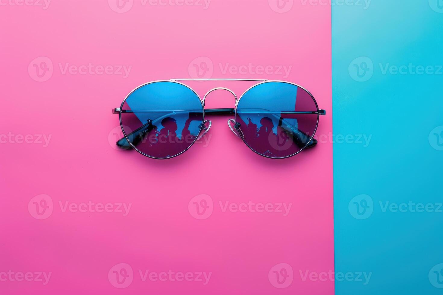 Colorful sunglasses on a vibrant background with silhouettes reflected in the lenses photo