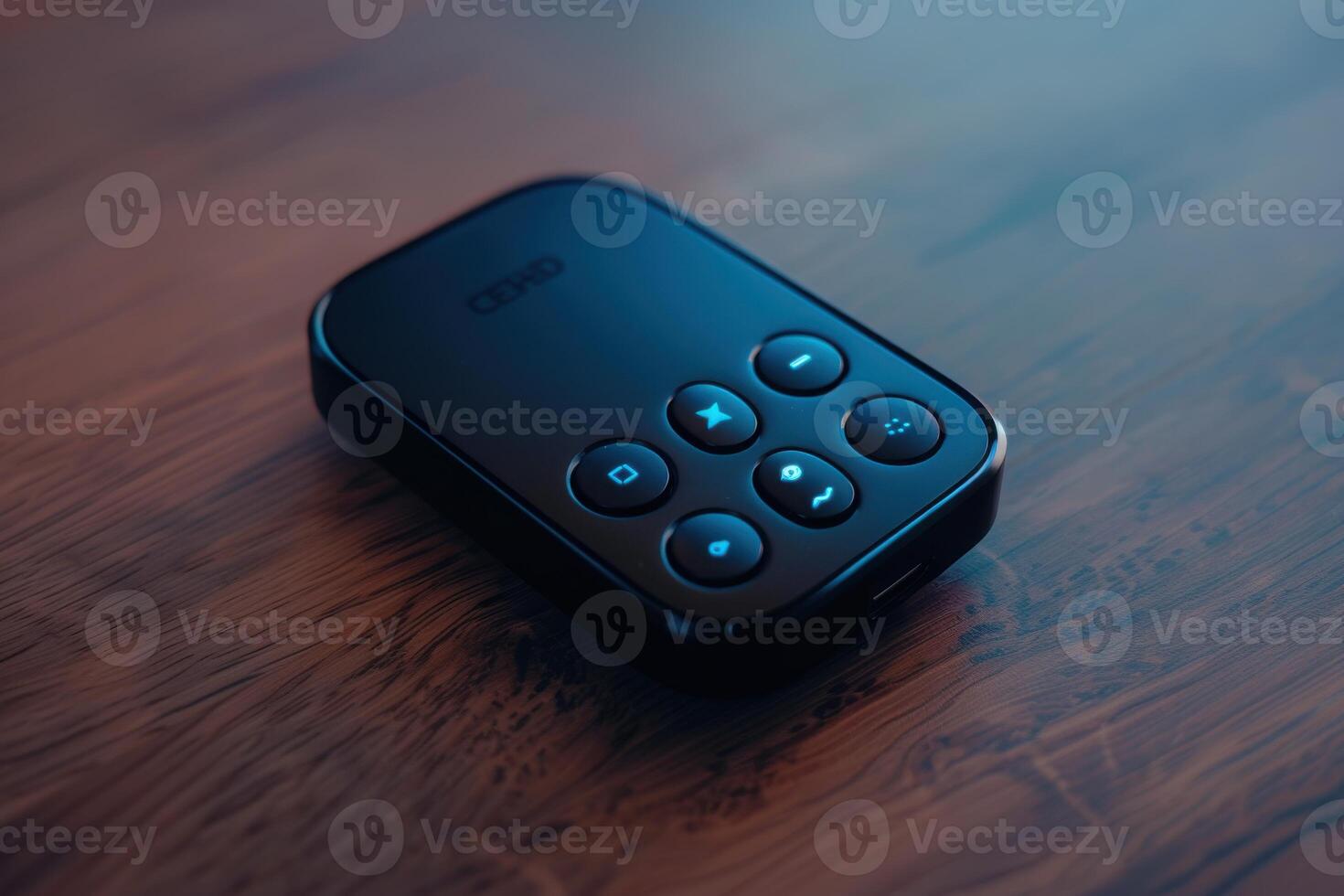 Close-up view of a remote control on a wooden table in soft lighting photo