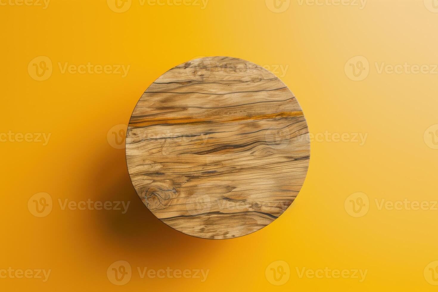 Round wooden table on a bright yellow background photo
