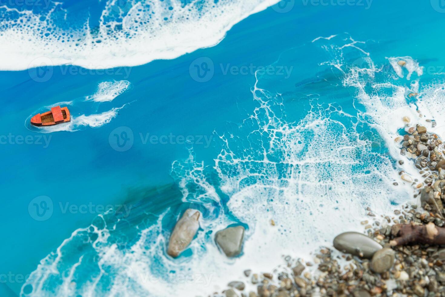 Resin art with ocean waves, boat and stone beach. Epoxy art composition photo