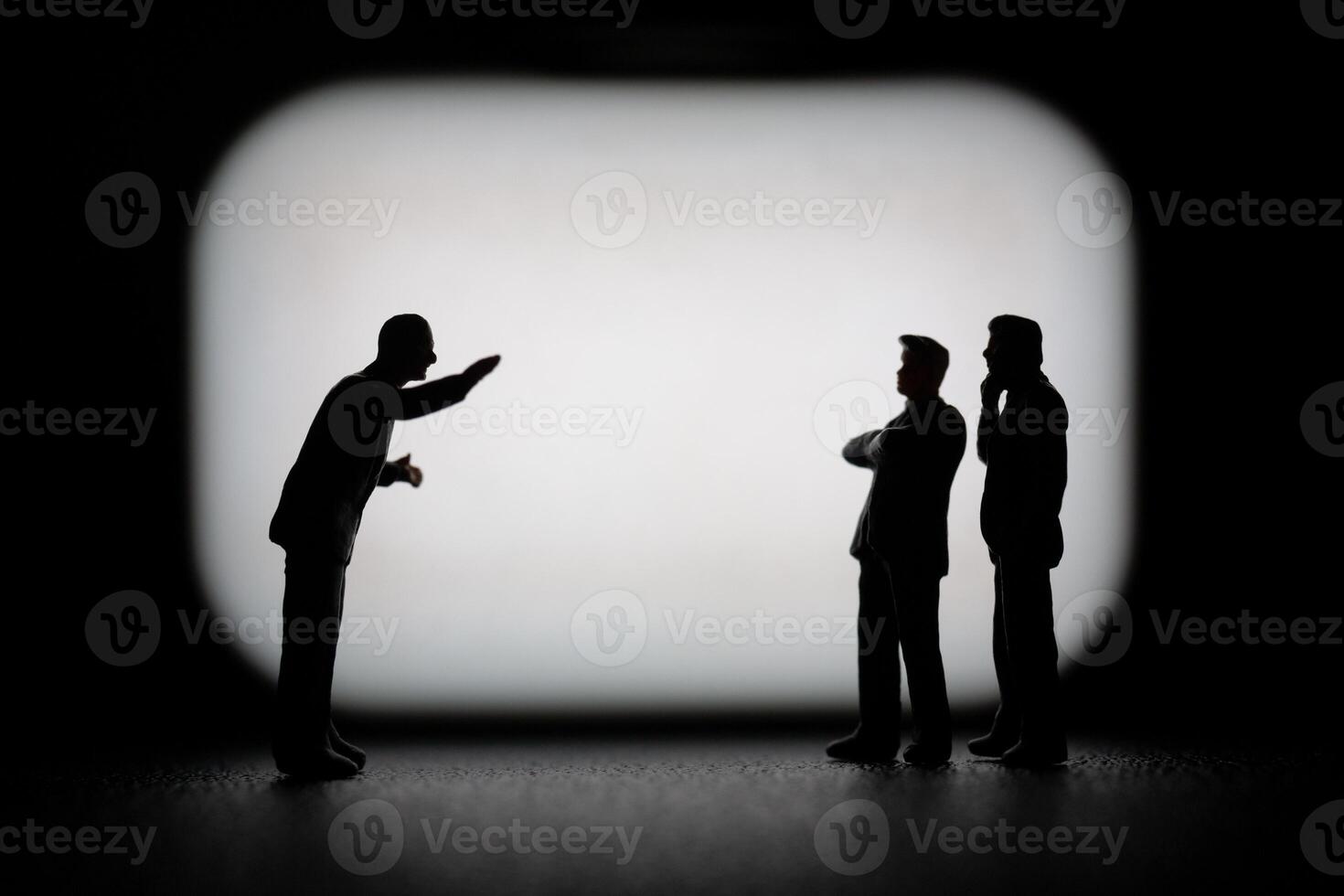 Miniature businessman in a professional agreement, with a blurred background to emphasize the interaction. photo