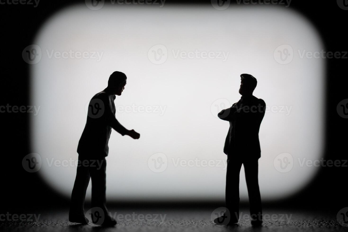 Miniature businessman in a professional agreement, with a blurred background to emphasize the interaction. photo