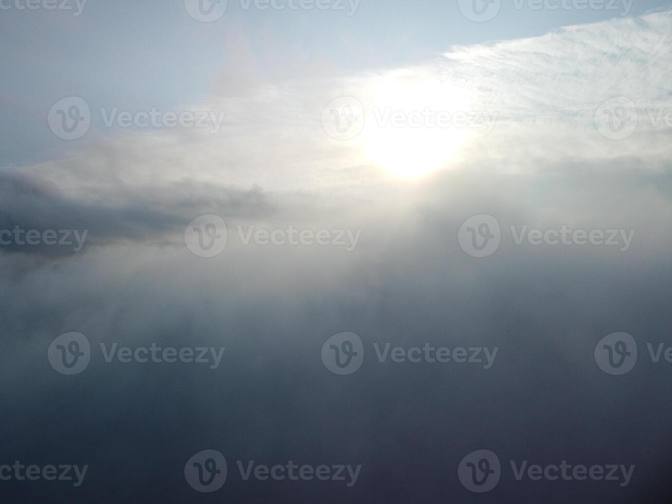 Aerial view. Blue sky sun and fog over calm sea. The drone flies over foggy and fluffy clouds. Abstract aerial nature summer ocean sunset sea and sky background. Vacation, travel and holiday concept. photo