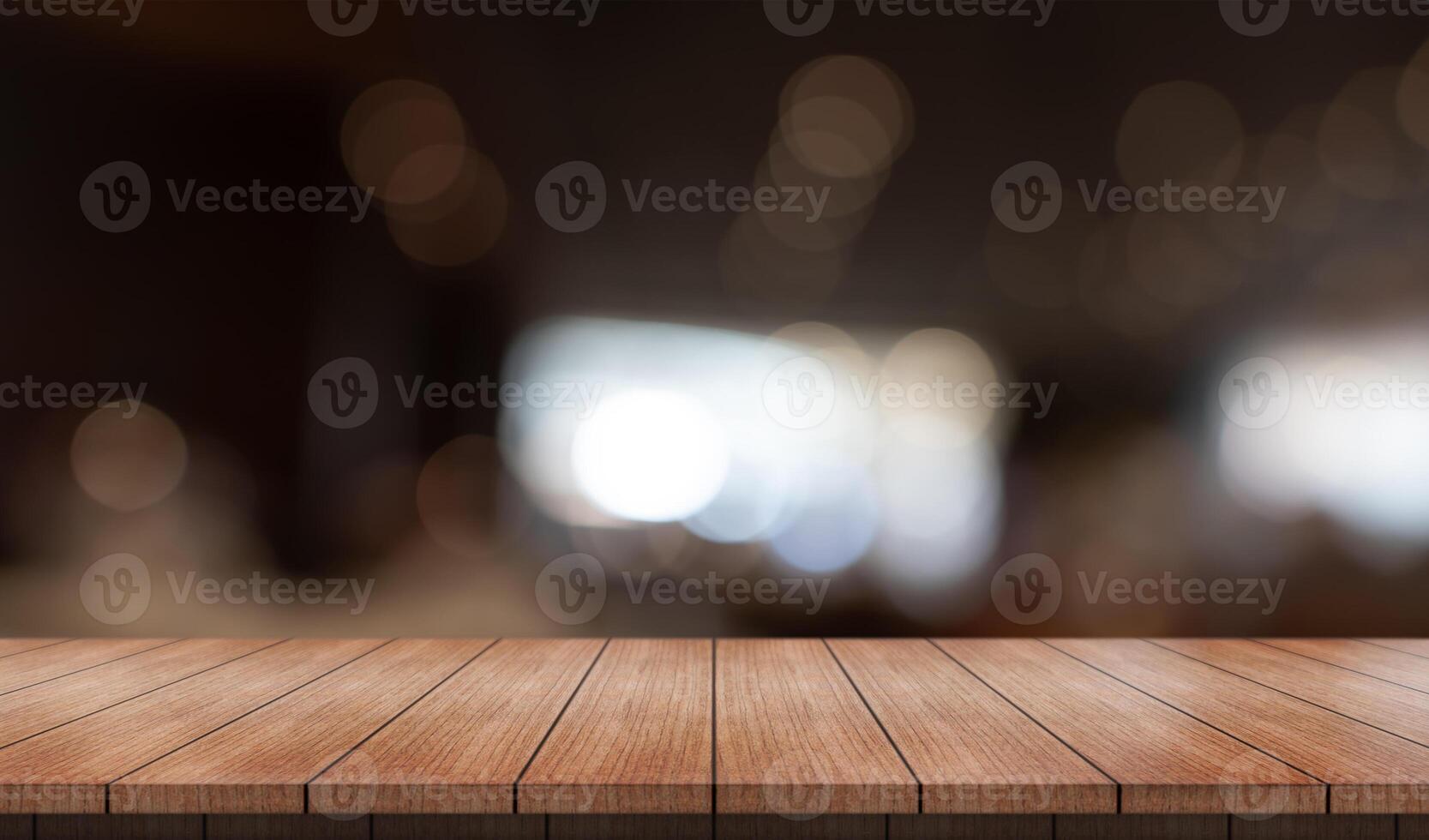 Empty wooden table top with lights bokeh on blur restaurant background photo