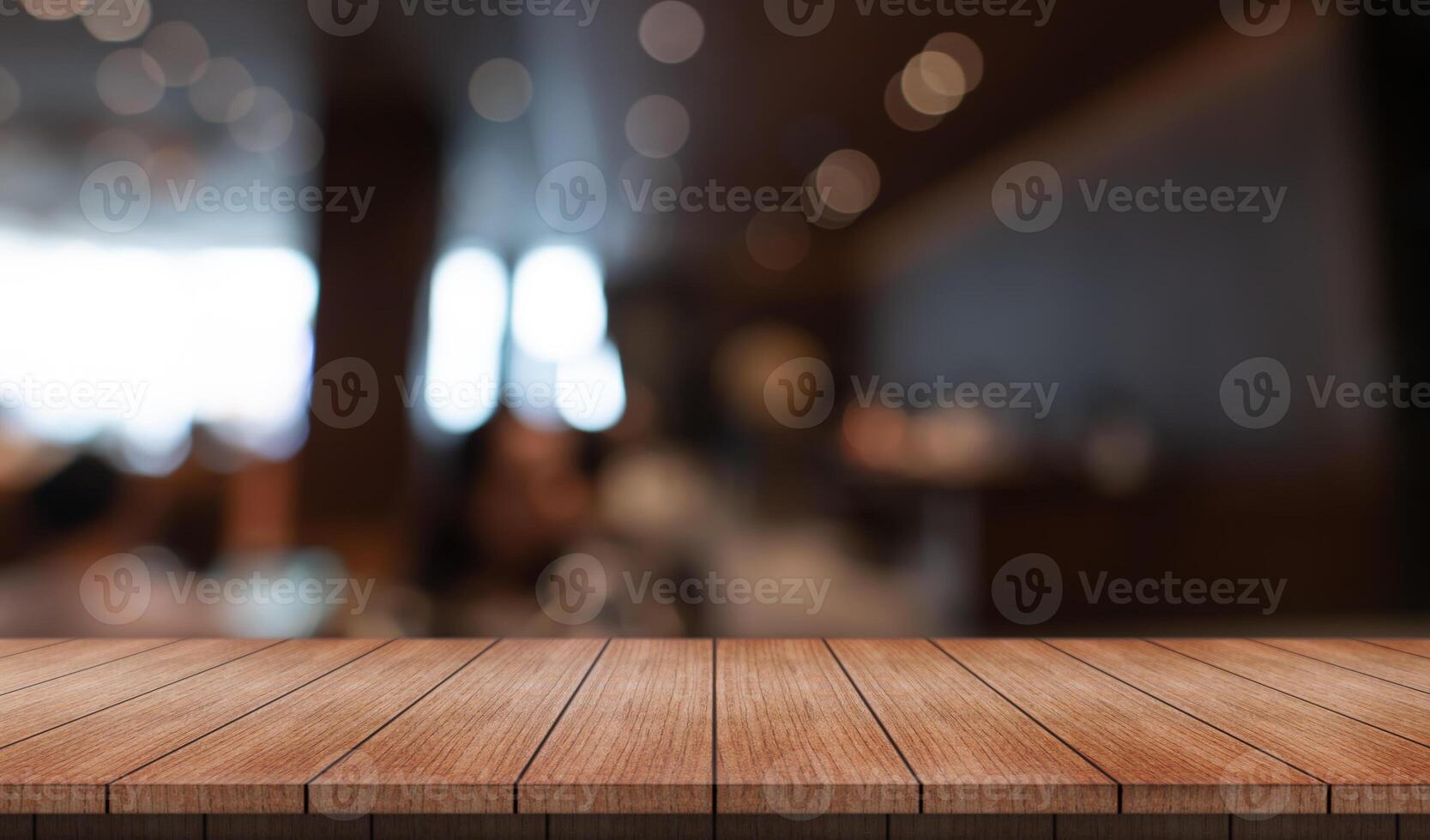 Empty wooden table top with lights bokeh on blur restaurant background photo