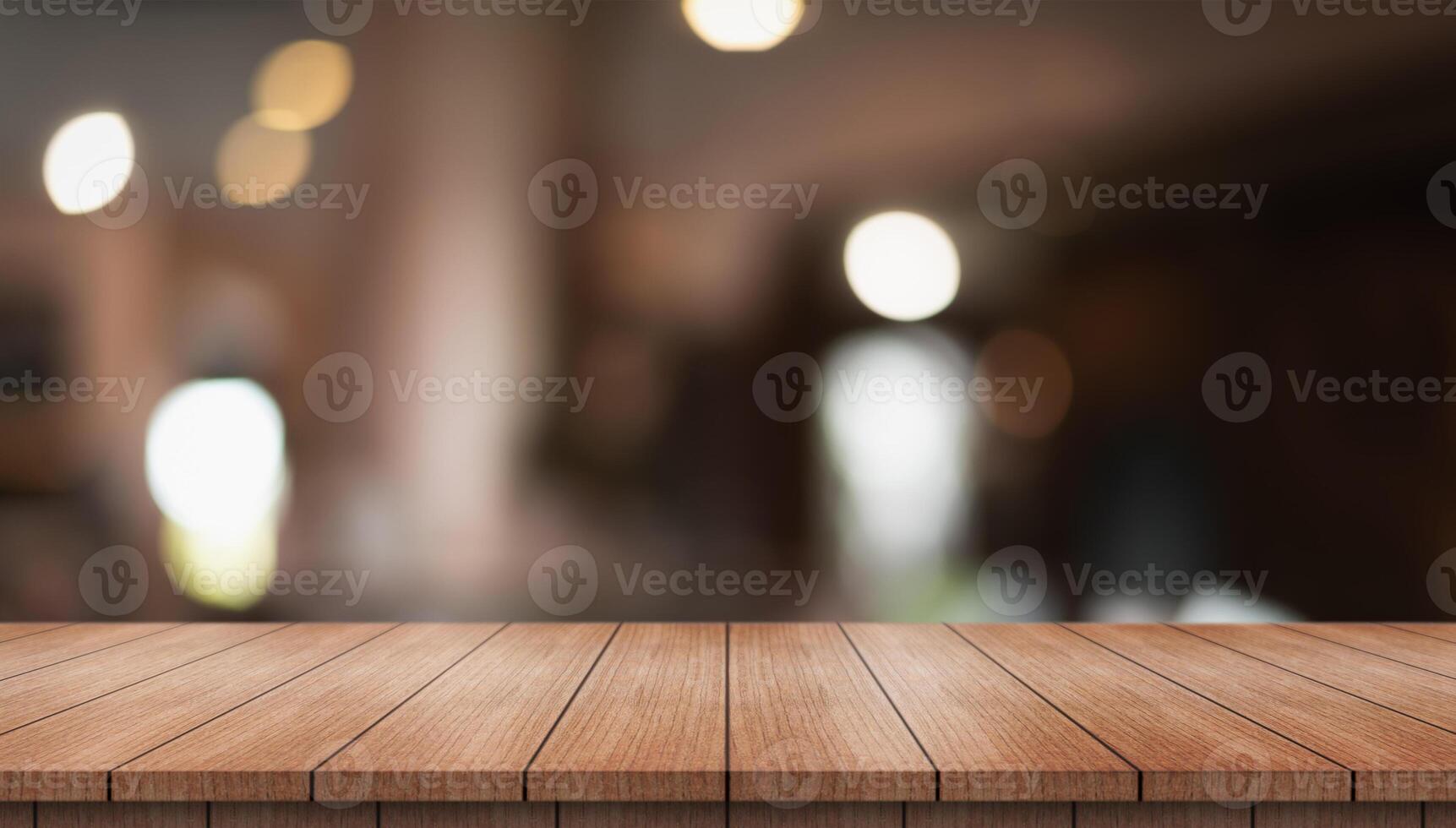 Empty wooden table top with lights bokeh on blur restaurant background photo