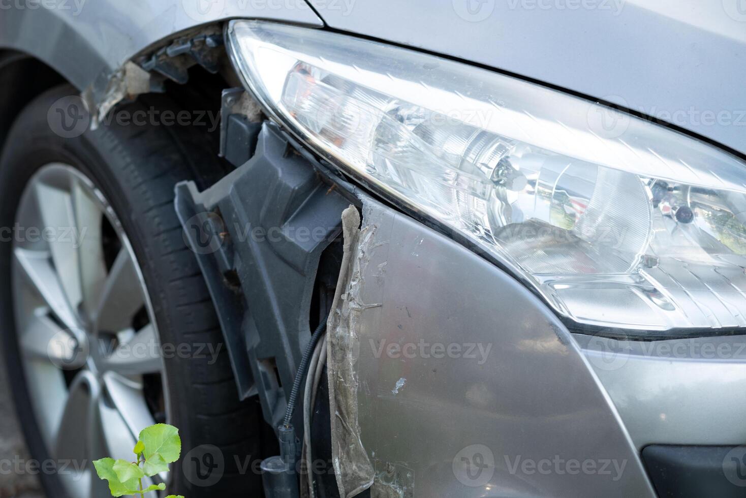 The front of the car damaged in an accident. damaged headlamp after collision close-up photo