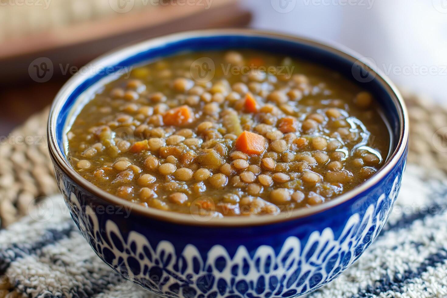 Hearty vegan lentil stew with vegetables in a rustic bowl on a wooden surface photo