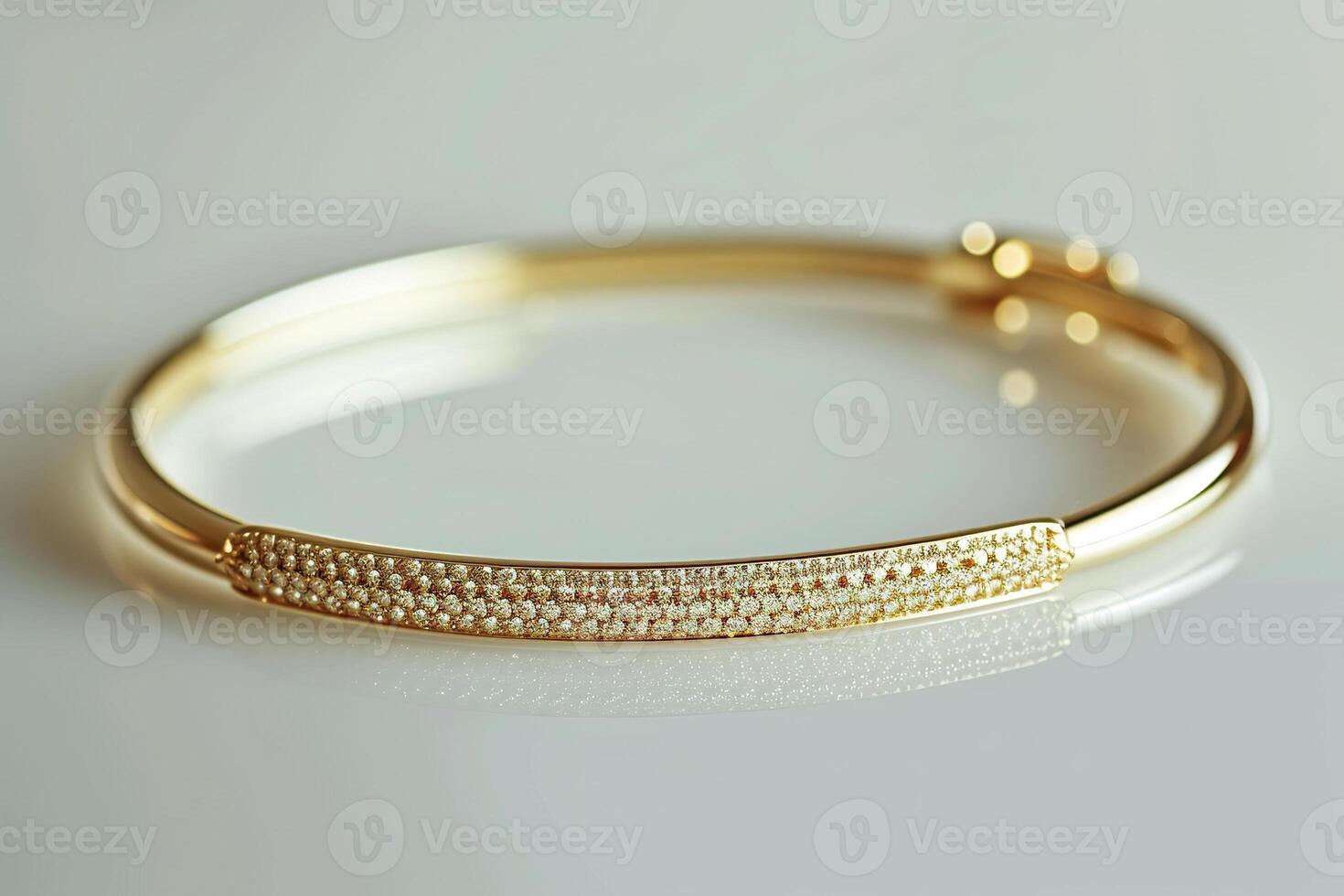 Elegant gold bangle bracelet with intricate detailing and sparkling accents. photo
