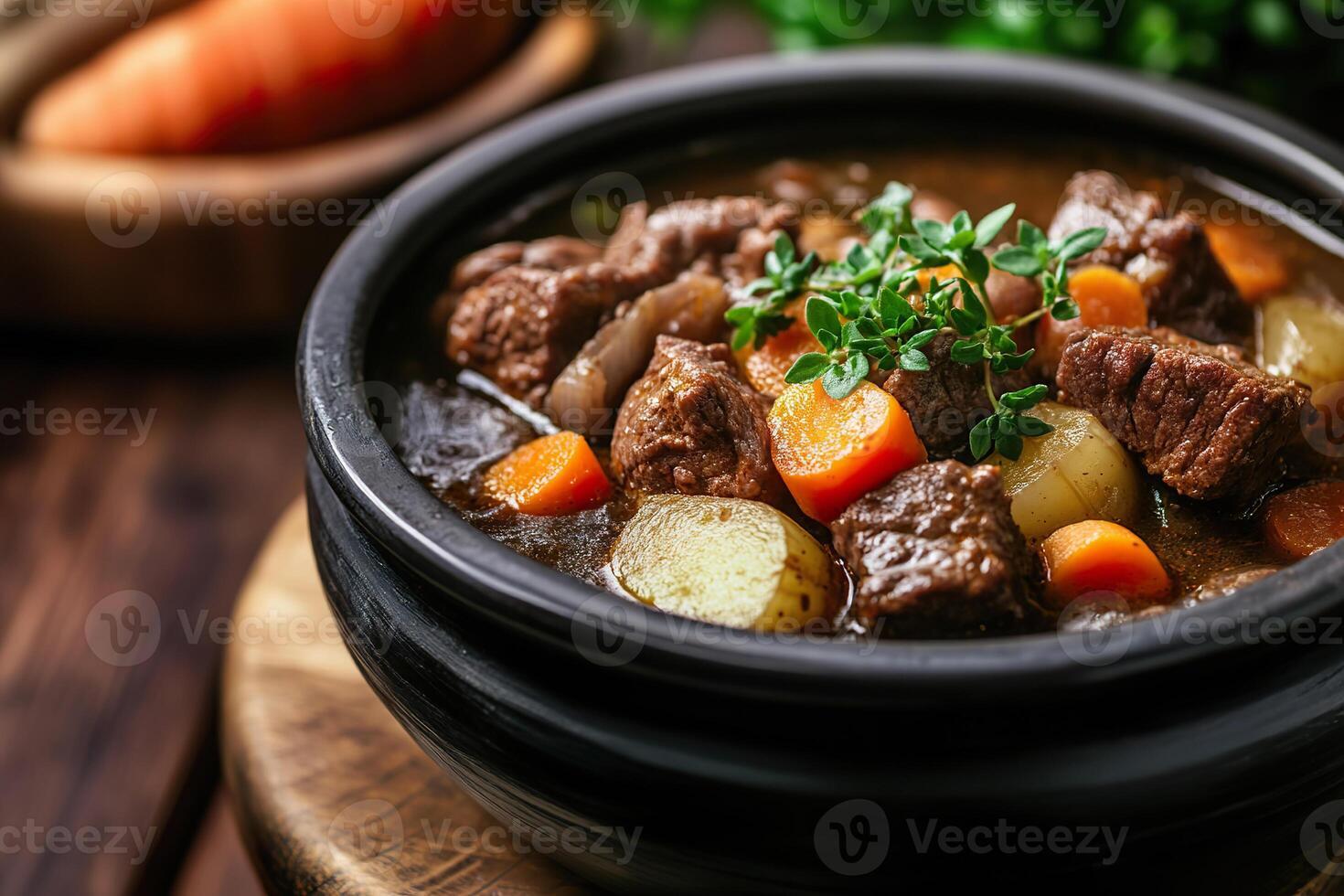 Delicious beef stew with vegetables in a rustic bowl and blurred background. photo
