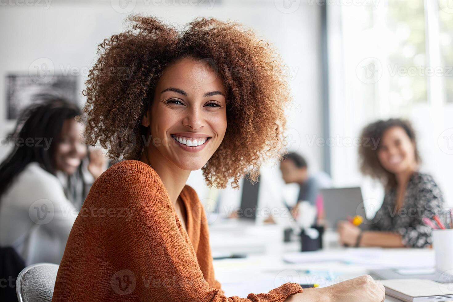 Smiling professionals collaborating in a bright office space during work hours photo