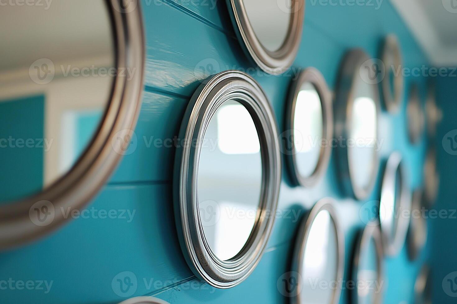 Decorative mirrors reflecting light on a blue wall in a contemporary interior photo