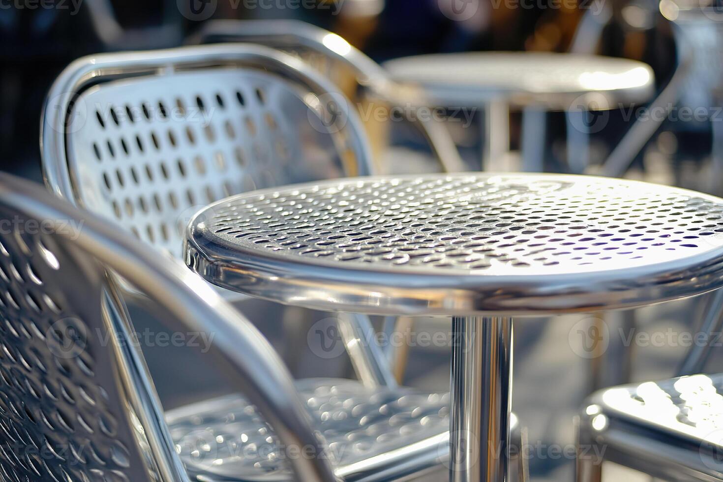 Steel cafeteria tables and chairs in a busy dining area. photo