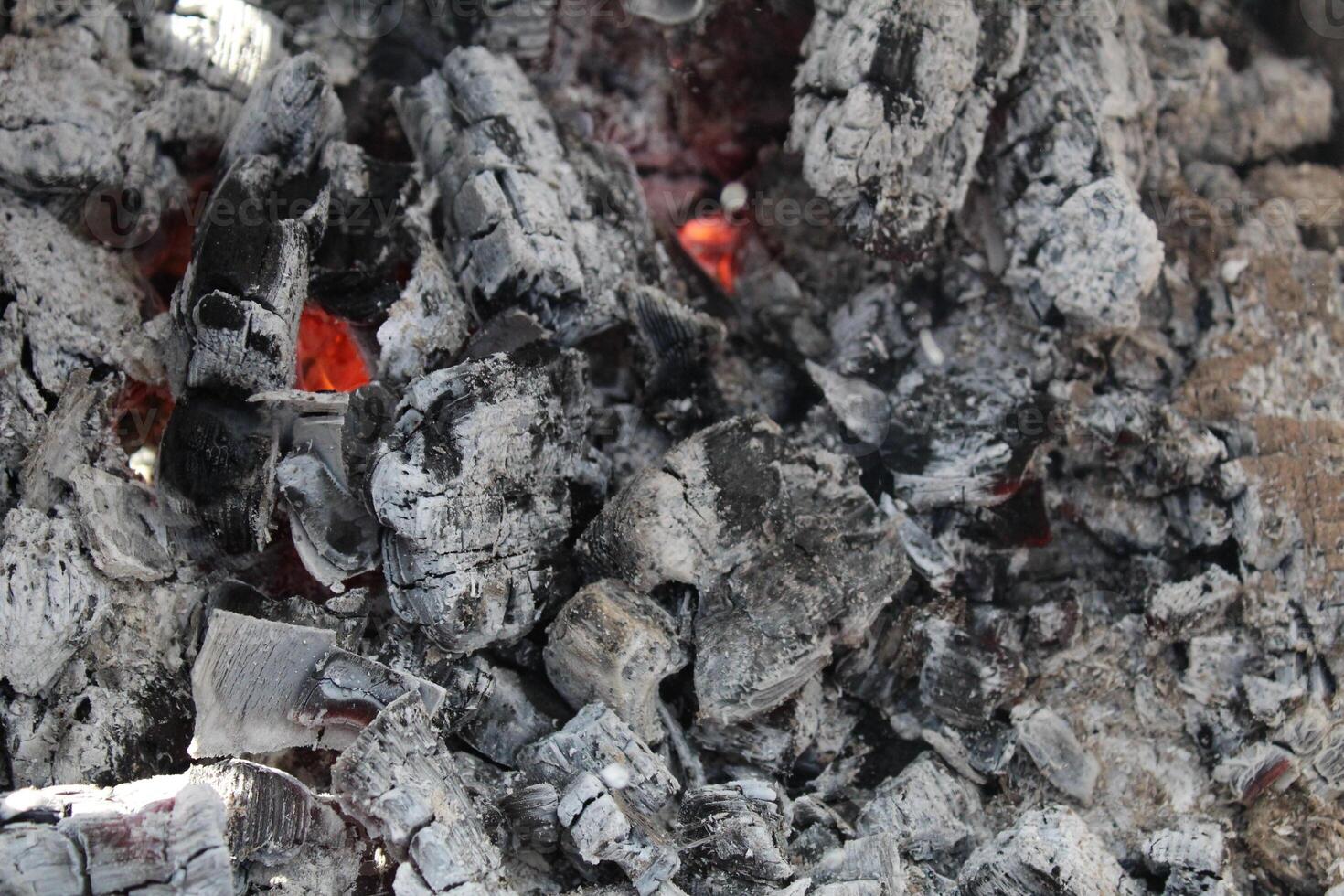 Ash embers close-up black and white grey with red weekend barbecue holiday background photo