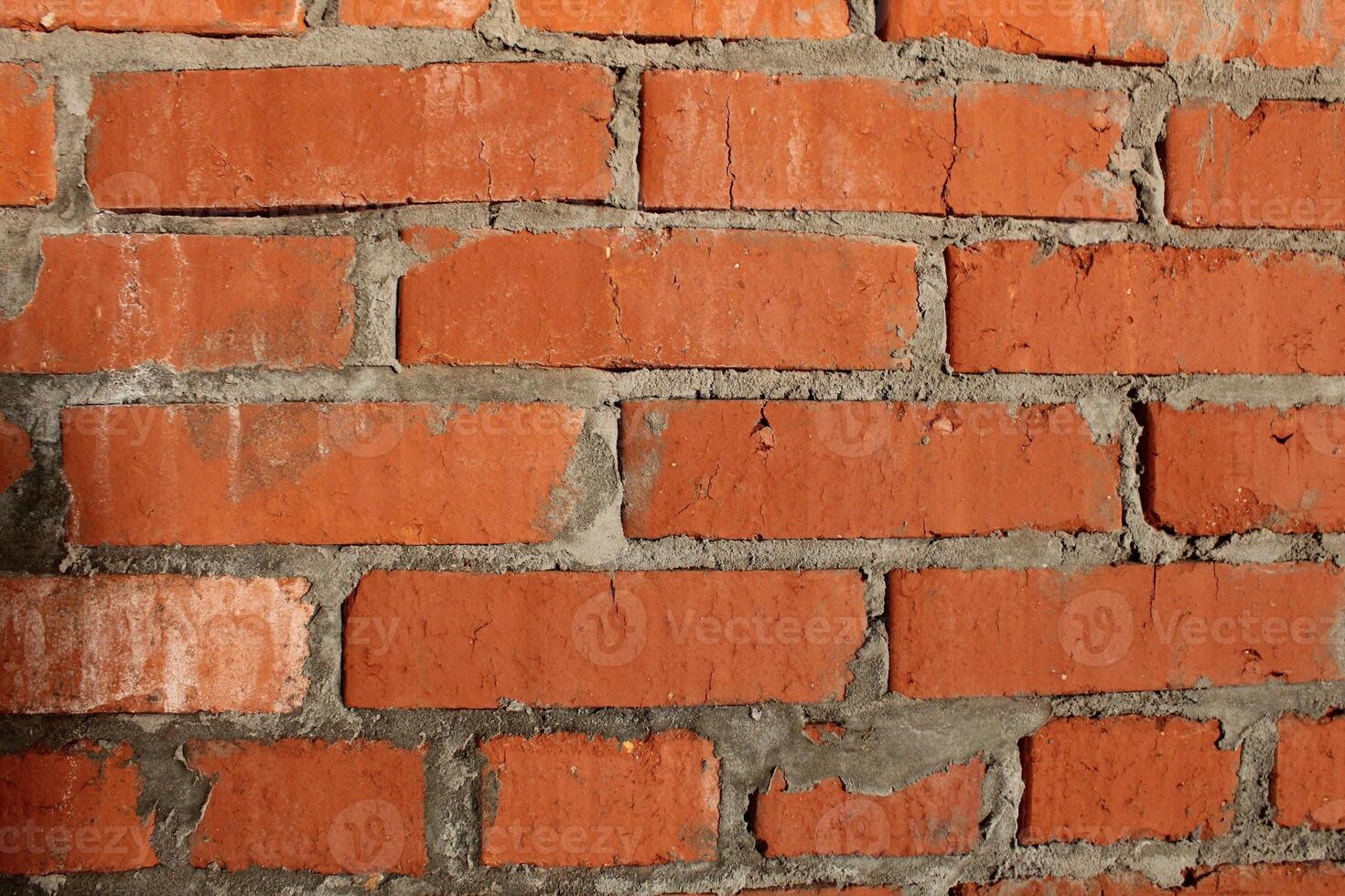 brick macro photo. Brick wall, close-up of red bricks with concrete between the seams. Construction background photo