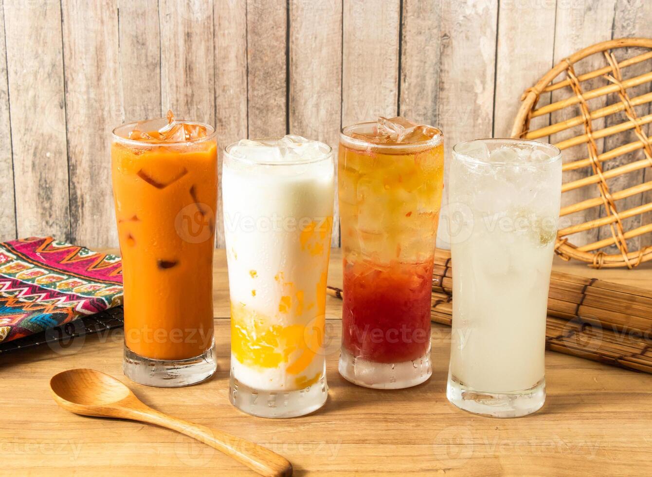 Assorted Thai Iced Drinks Ice Thai Milk Tea, Creamy Mango Milk iced Tea, Spring Bud Grapefruit iced tea, Refreshing Ice Lemonade served in tall glasses with ice cubes side view of taiwan drink photo