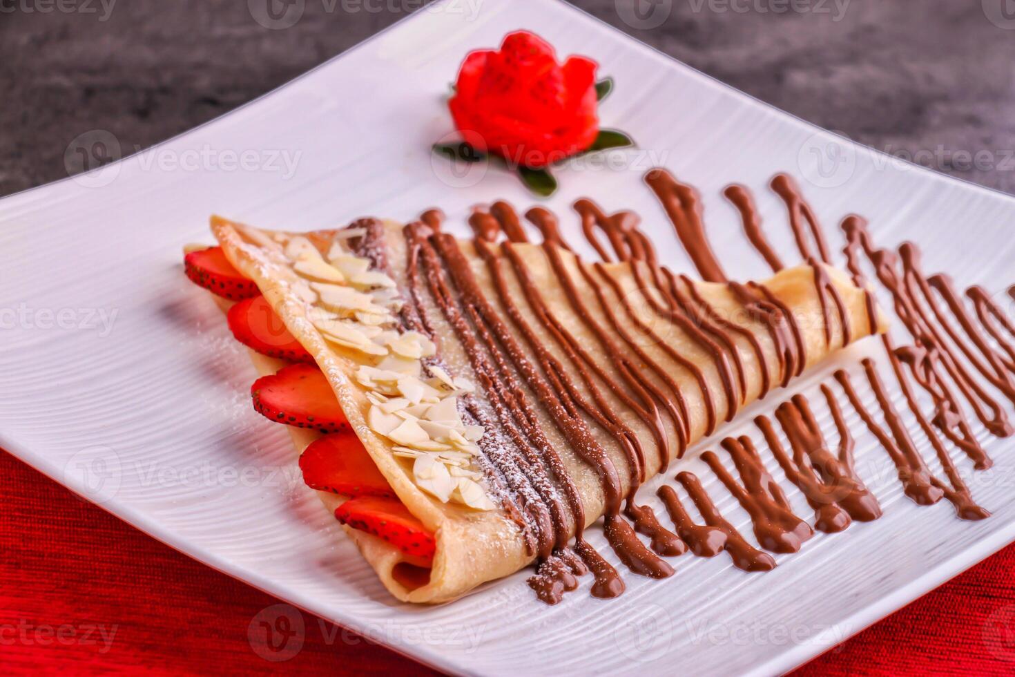 Decadent Chocolate Strawberry Crepe served in plate isolated on table side view of indulgent dessert photo