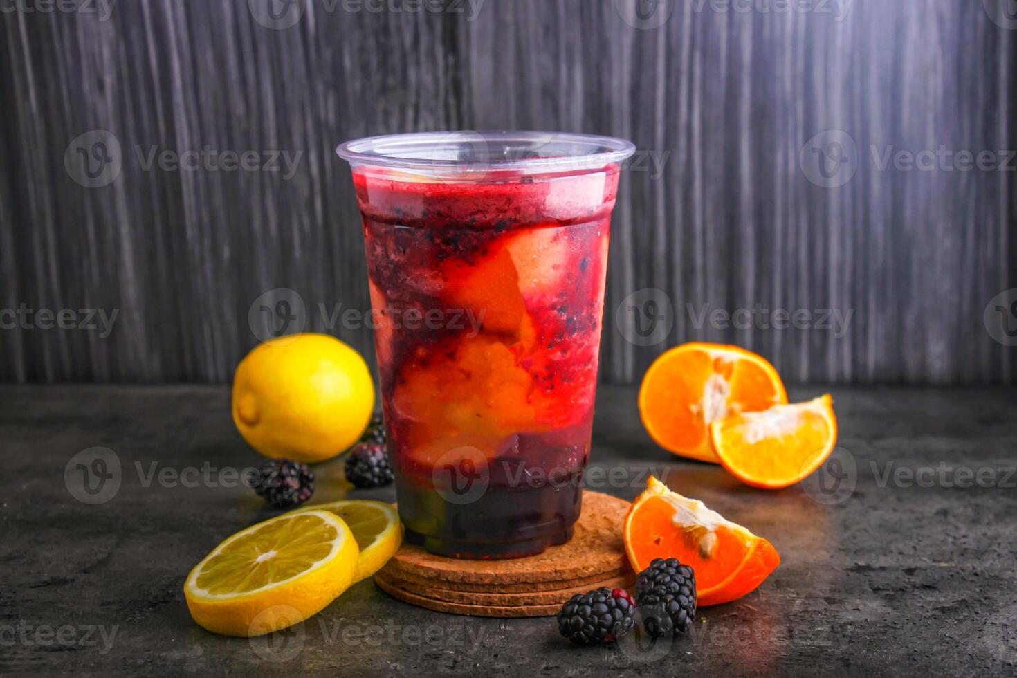 Refreshing Blackberry Lemonade with Citrus Twist with fresh lemon slices and blackberries in glass isolated on background side view of healthy and delicious beverage photo