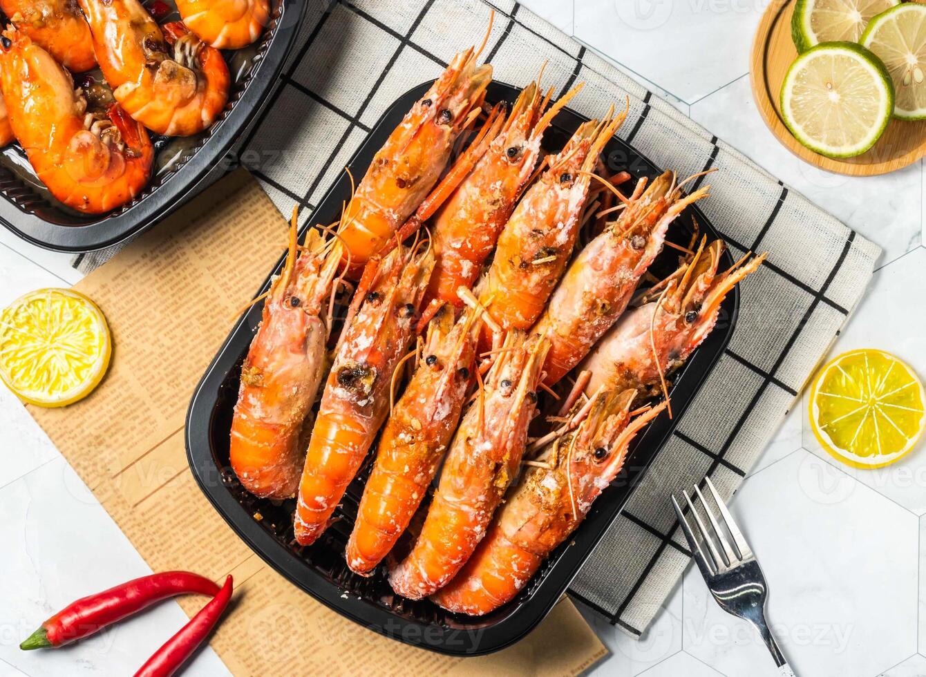 Salted Grilled Shrimp with Lemon and fork served in black tray isolated on table top view of taiwan seafood photo