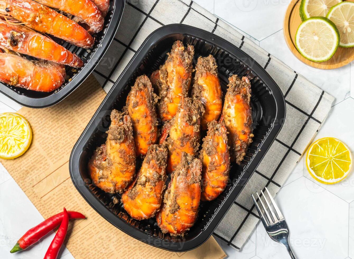 Spicy Pepper Grilled Shrimp with Lemon and fork served in black tray isolated on table top view of taiwan seafood photo