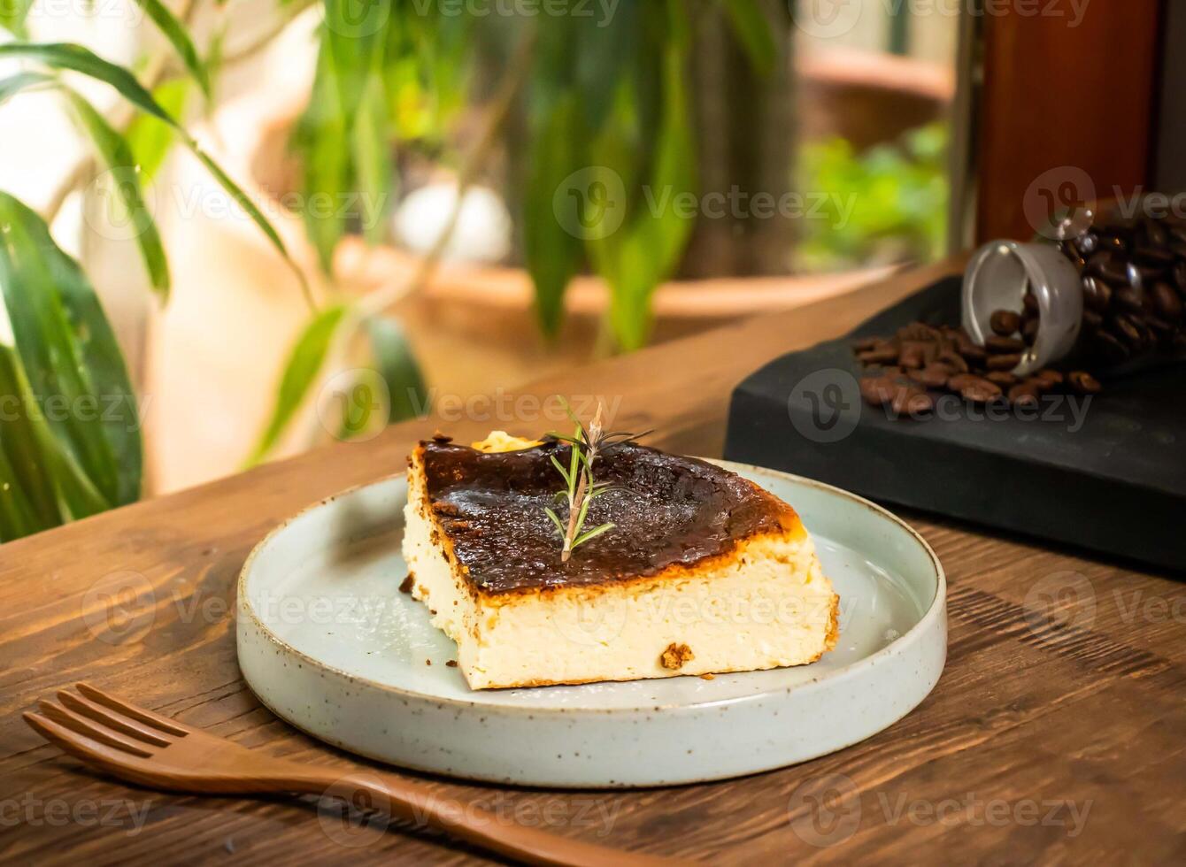 Basque cheesecake slice with fork served in dish isolated on table side view of taiwan baked cafe dessert food photo