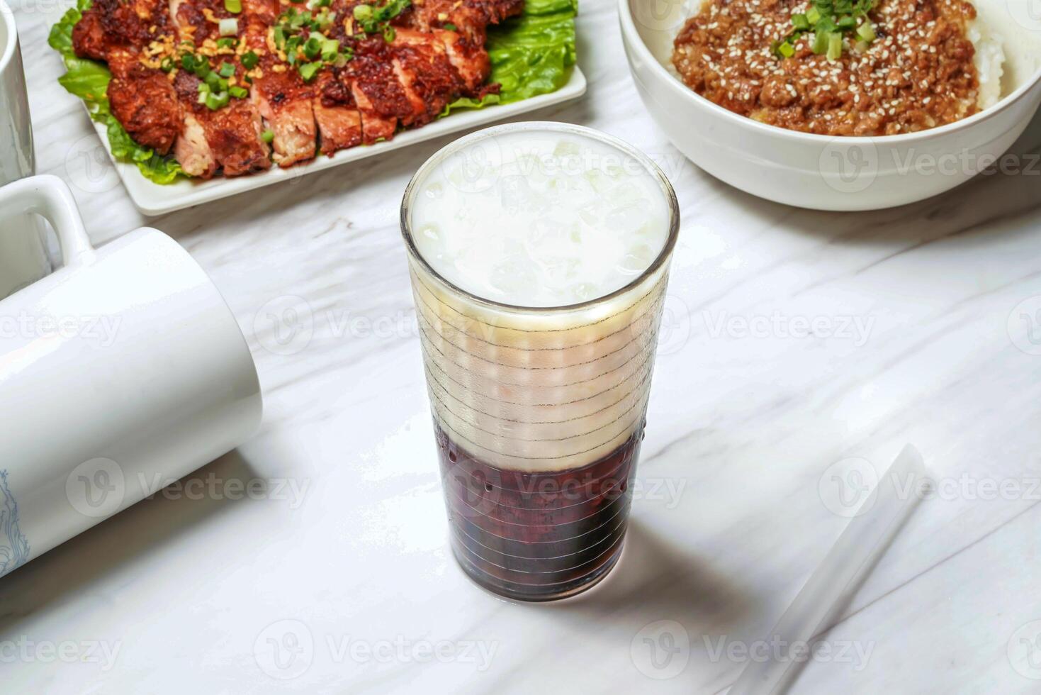 Taiwanese red bean ice tea with pork chop, minced pork rice served in dish isolated on marble background side view of taiwan food photo
