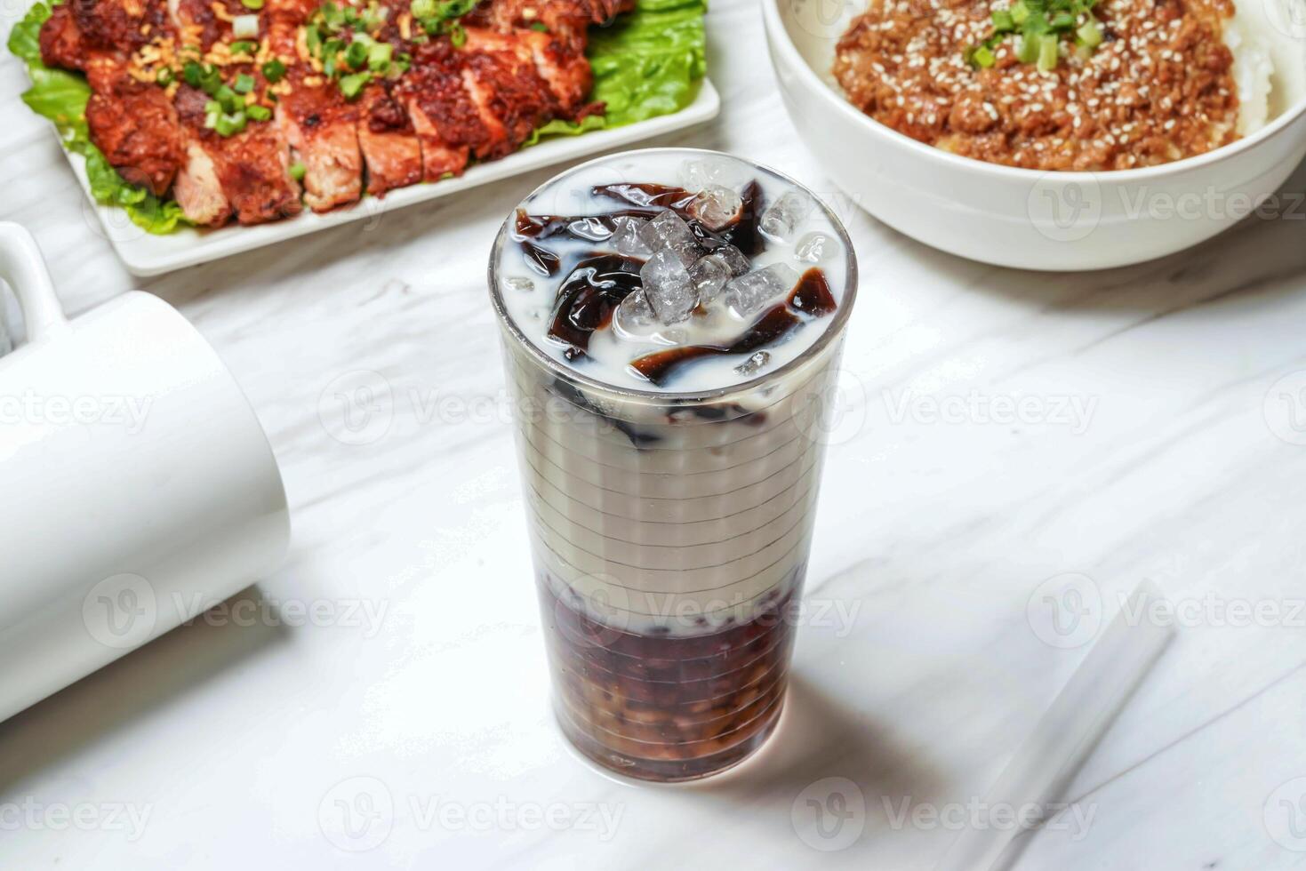 Taiwanese coffee jelly red bean ice tea with pork chop, minced pork rice served in dish isolated on marble background side view of taiwan food photo