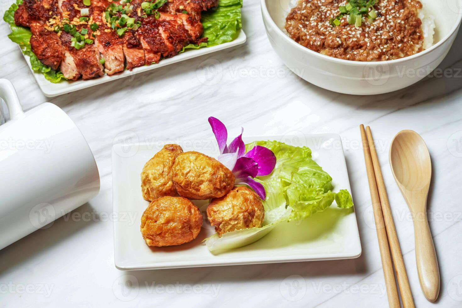 Fried squid balls with pork chop, minced pork rice served in dish isolated on marble background side view of taiwan food photo