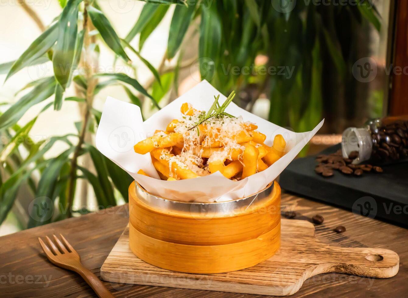 Truffle fries with parmesan cheese served in dish isolated on table side view of taiwan baked food photo
