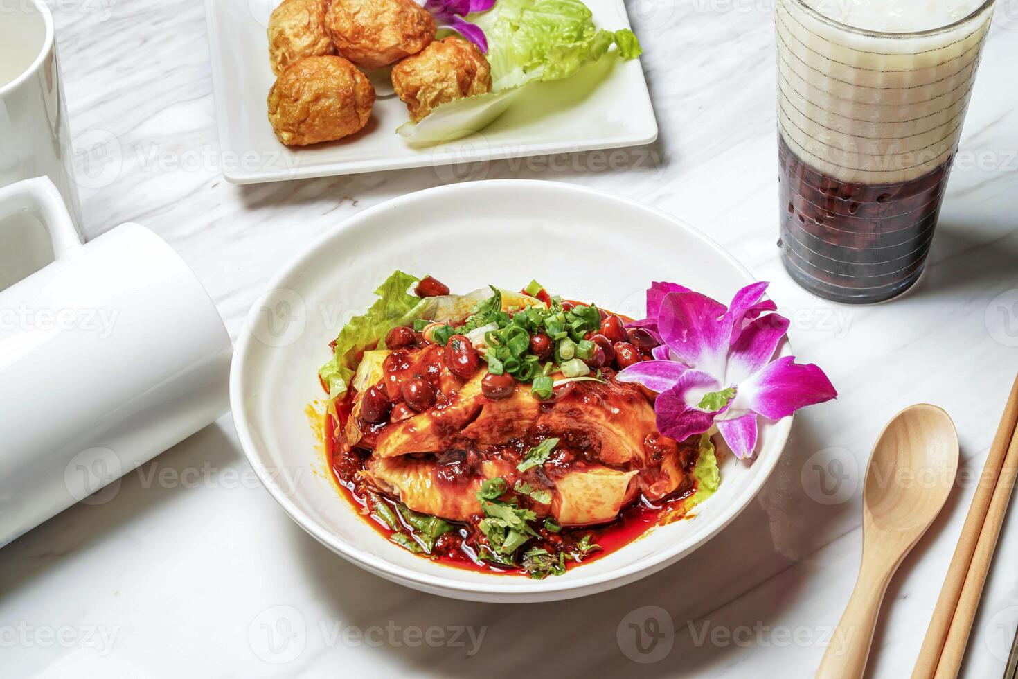Delicious saliva chicken with Dancing Sakura Shrimp, Fried squid balls, Taiwanese red bean ice tea served in dish isolated on marble background side view of taiwan food photo