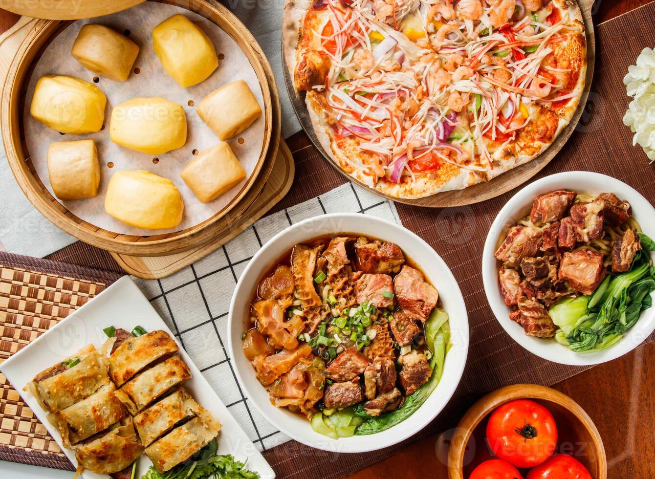 Diverse Taiwanese Cuisine Feast assorted Steamed Mantou Buns, Seafood pizza, Beef Scallion Pancakes, Beef Noodle Soup with Tender Tripe top view isolated on table photo