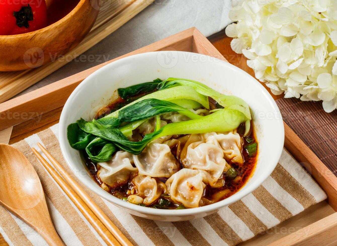 Spicy Szechuan Wonton Soup in bowl served in wooden tray side view of taiwan food photo