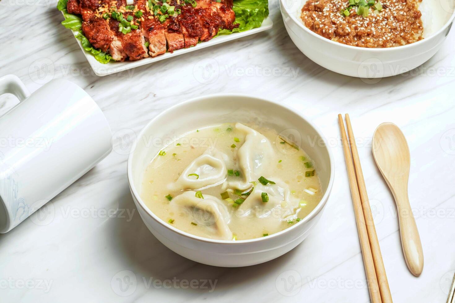 Handmade Soup Dumplings with pork chop, minced pork rice, served in dish isolated on marble background side view of taiwan food photo