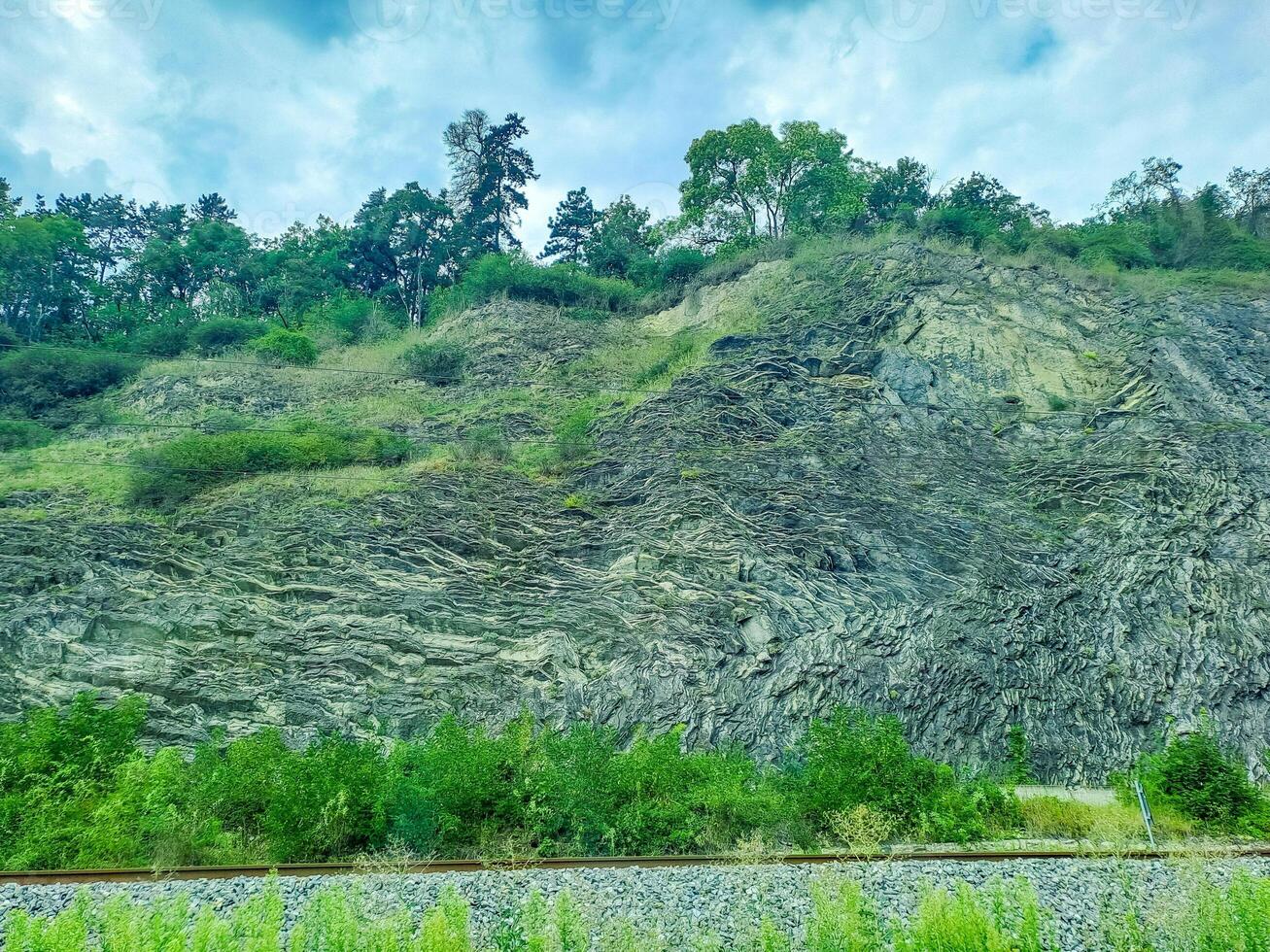 rocky mountains at the entrance to Prague, on which trees grow. Czech photo