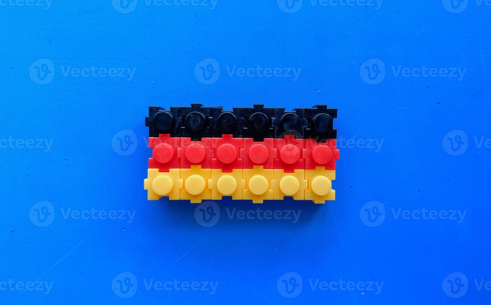 German flag on a blue background, built from a children toy construction set. photo