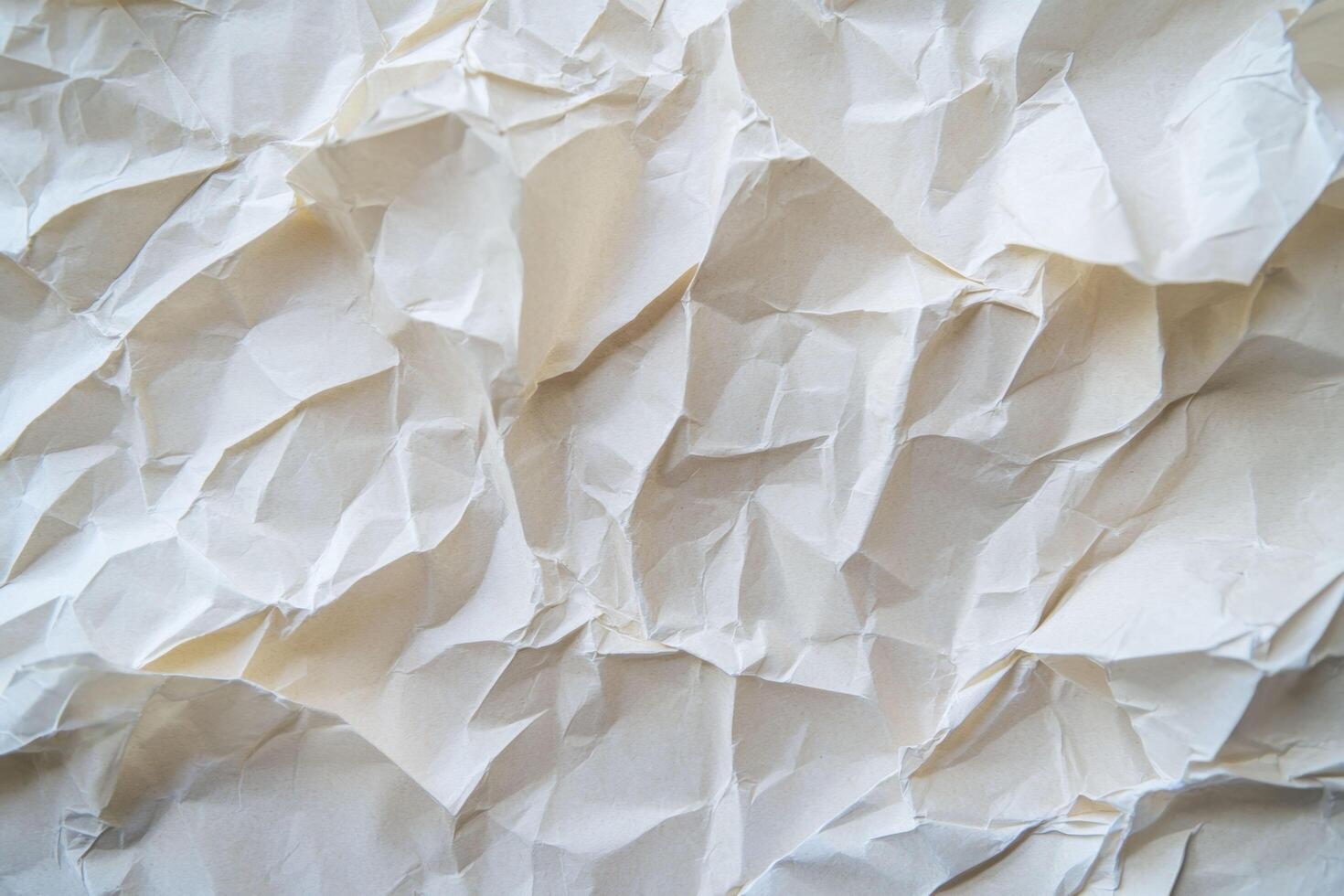 A crinkled paper texture background features a wrinkled, irregular surface with a tactile, aged appearance photo