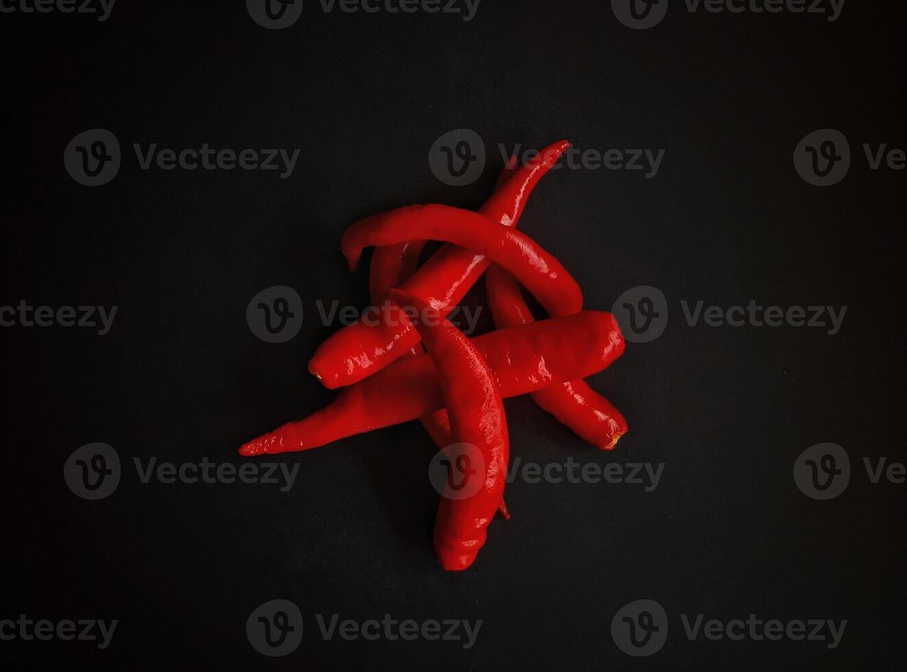 Front view of red chili pepper on a black background photo