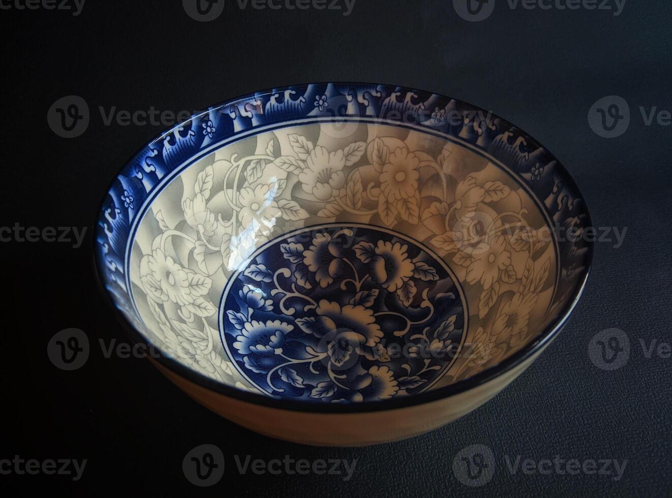 A blue and white bowl with a floral design photo