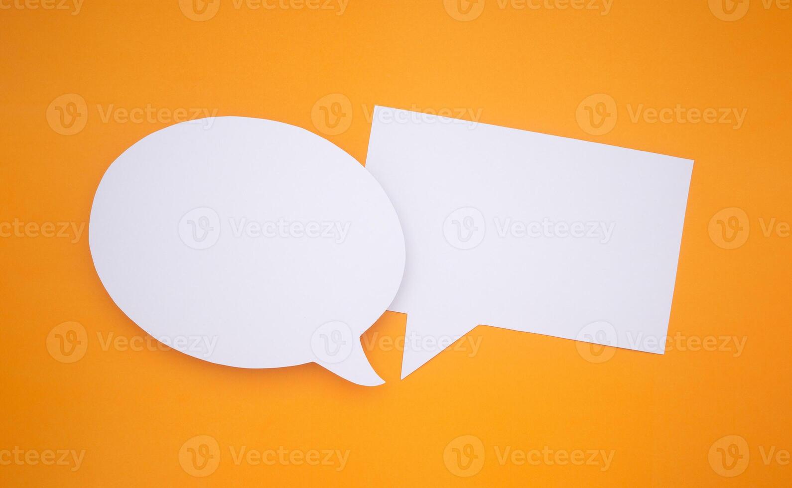 Speech bubble concept. Two empty speech balloons isolated on yellow background with copy space for text. Close-up photo