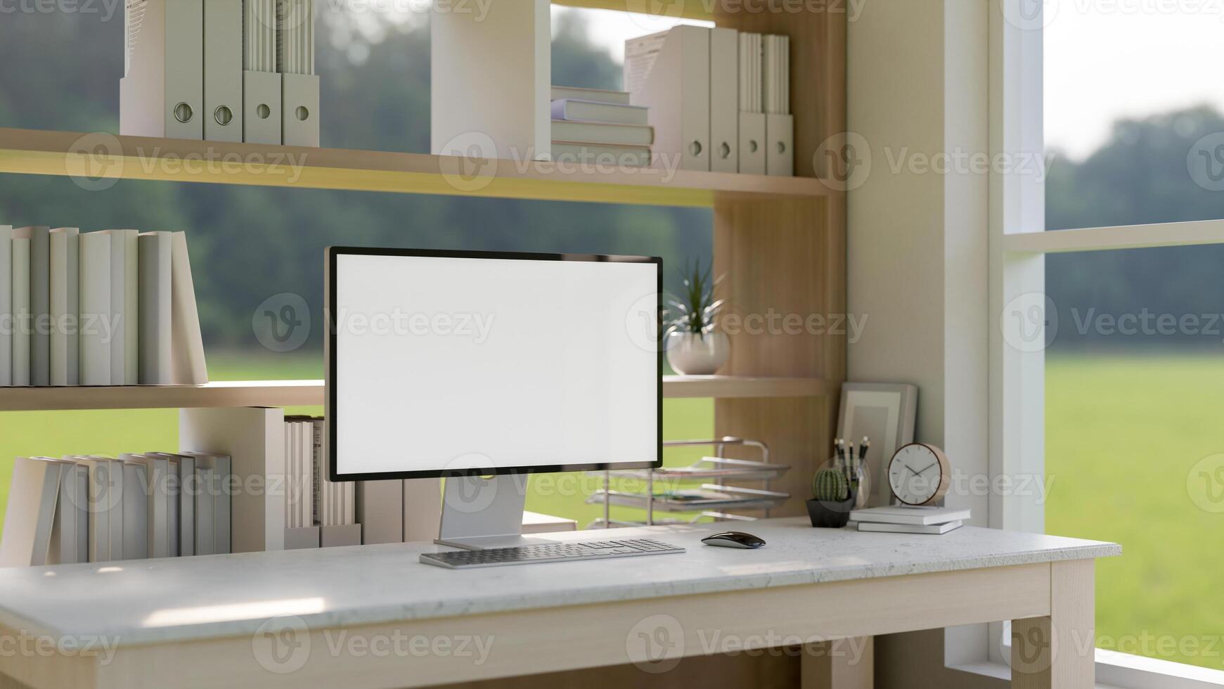 A computer mockup on a desk against a bookshelf in a contemporary room with a green field view. photo