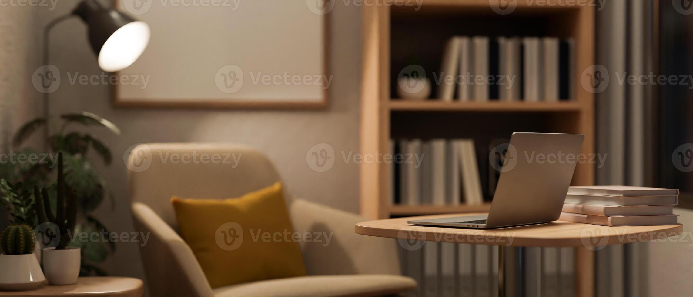 A modern home office at night with a laptop on a table, an armchair, and dim light from a floor lamp photo