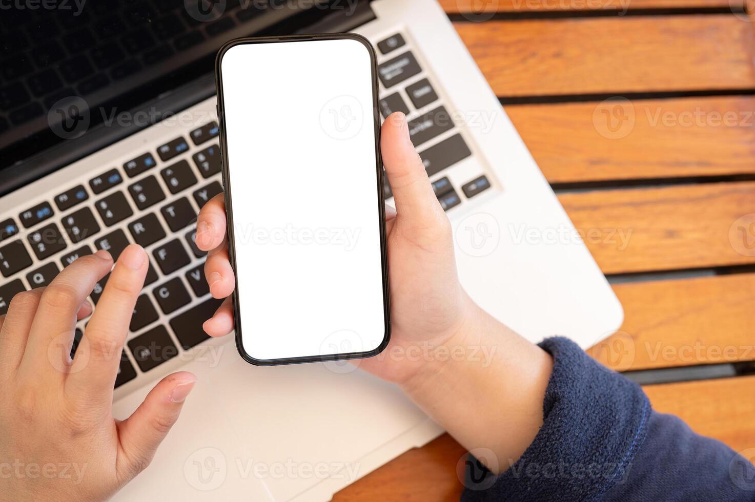 Top view image of a woman using her smartphone while working remotely at a cafe. photo