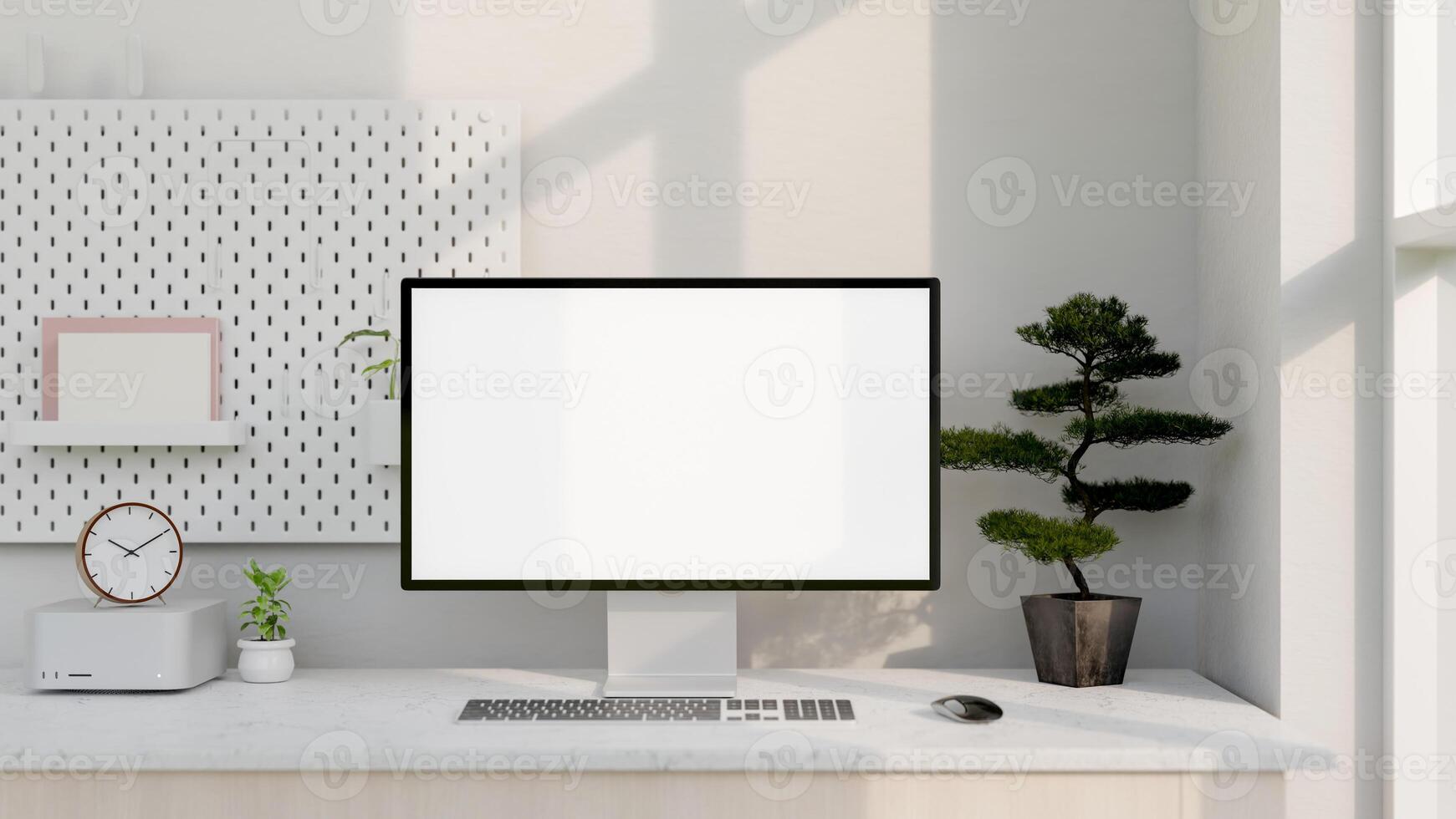 A modern white computer desk features a computer with a white-screen mockup and decor. photo