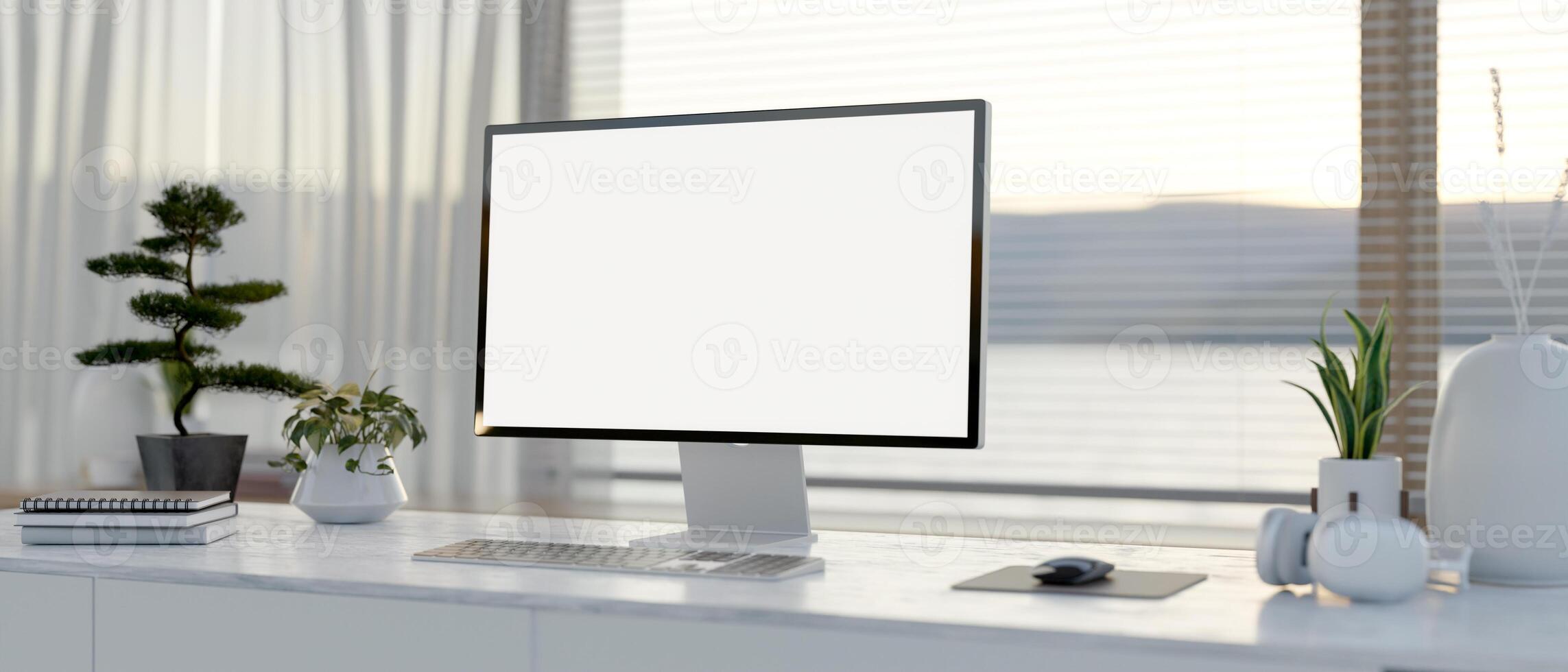 A computer desk featuring a computer with a white-screen mockup on a table in a modern white room. photo