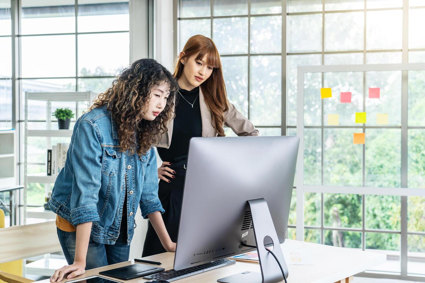 Collaboration of graphic design business people with computer in an office company, Two corporate women in creative marketing team working on project management photo