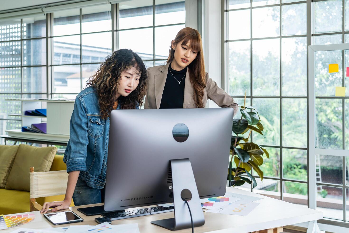 Collaboration of graphic design business people with computer in an office company, Two corporate women in creative marketing team working on project management photo