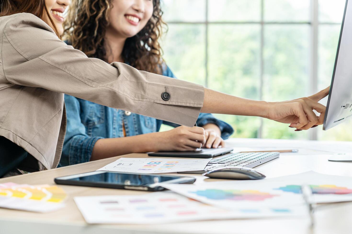 Collaboration of graphic design business people with computer in an office company. Two corporate women in creative marketing team working on project management, Designer teamwork, web design photo